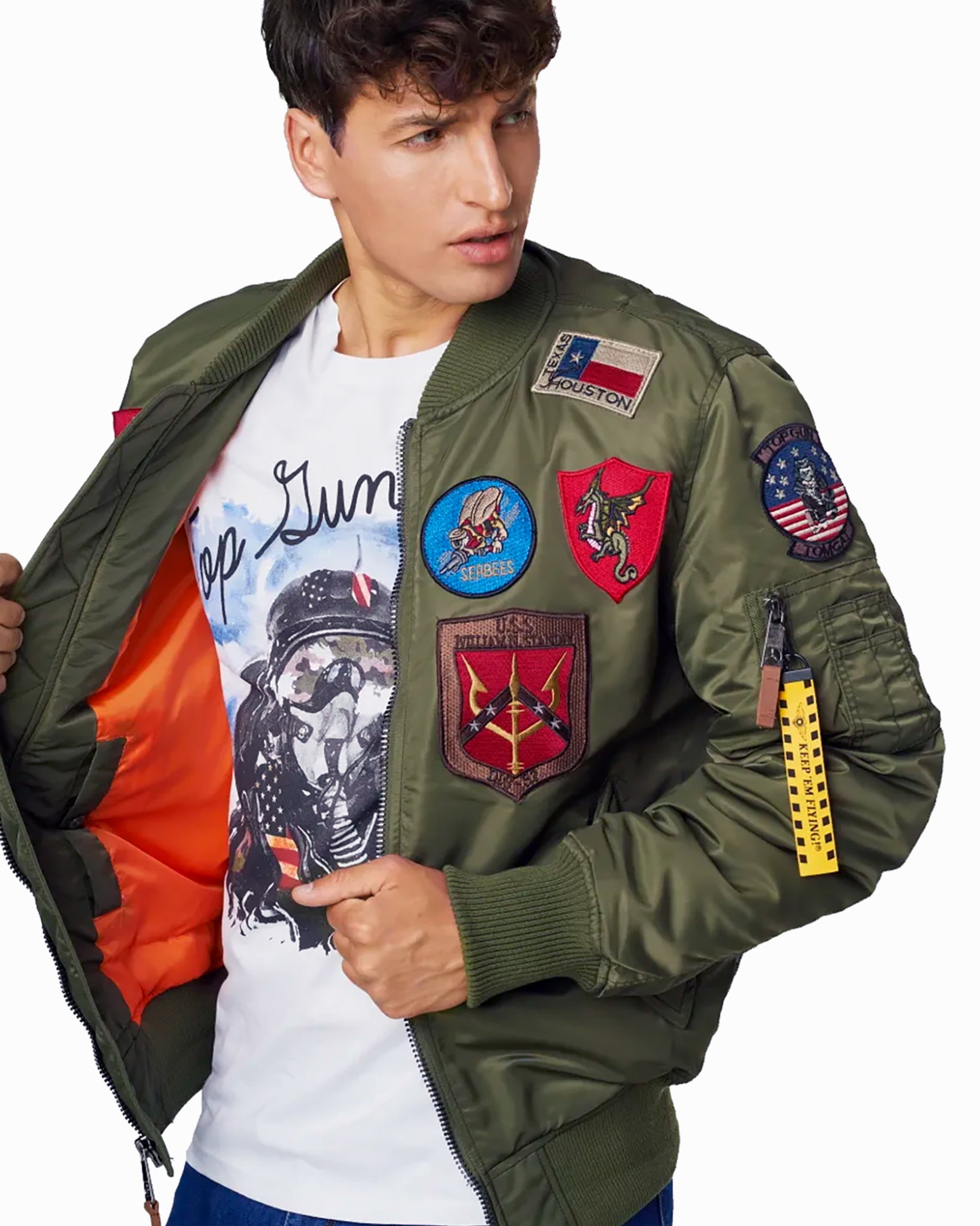 Man modeling the army green variant of the Top Gun® MA-1 bomber jacket with patches #color_olive
